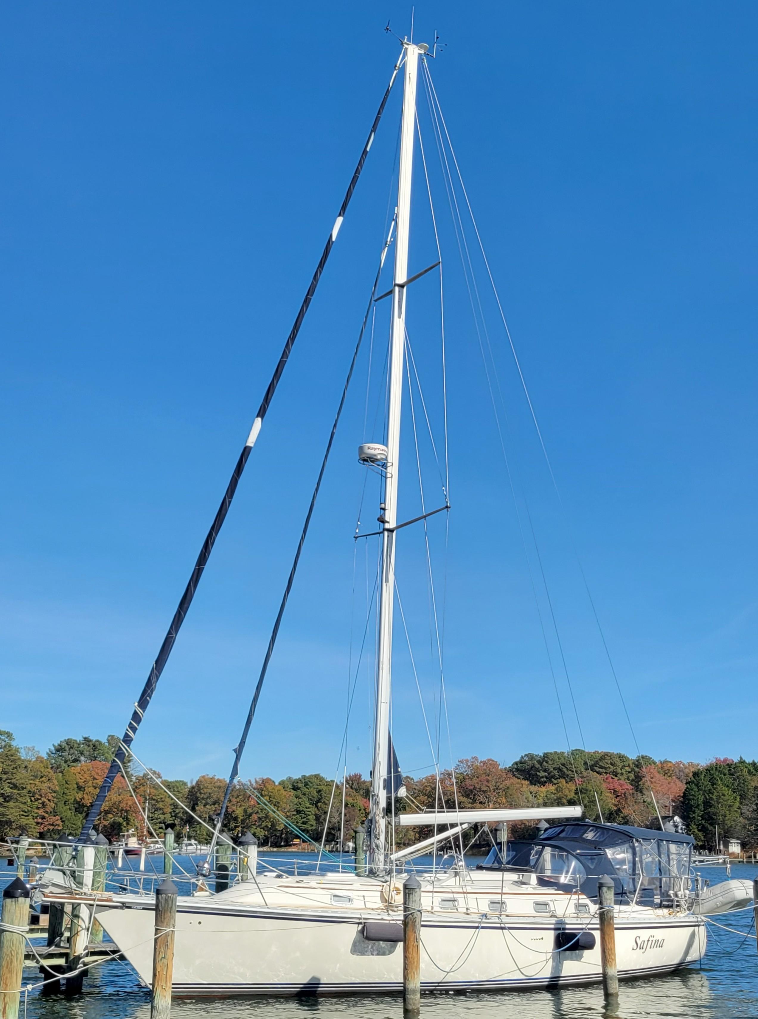 2003 Caliber 40 LRC SE sailboat docked under clear blue sky.