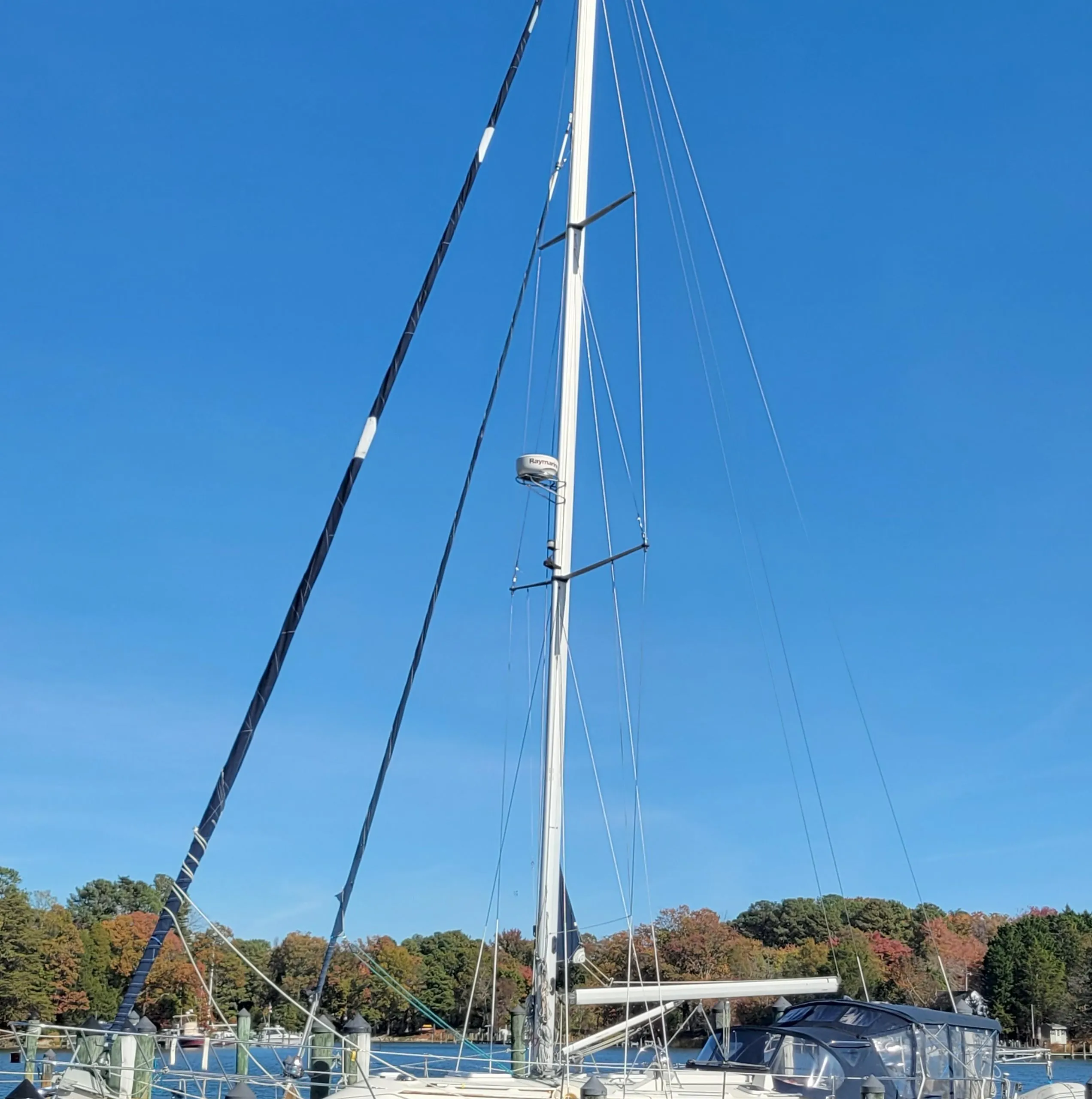 2003 Caliber 40 LRC SE sailboat docked under clear blue sky.