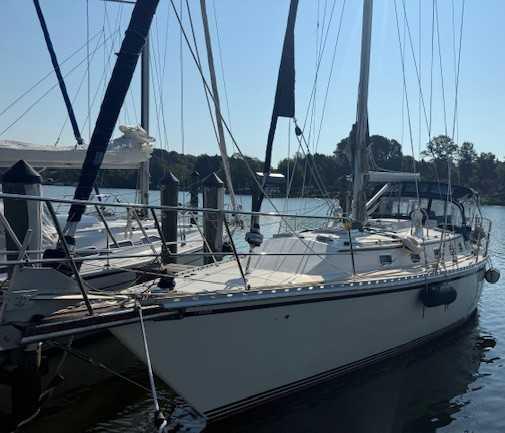 2003 Caliber 40 LRC SE sailboat docked at a marina, side view.