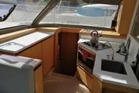 Interior of 2018 Nautitech 40 Open yacht kitchen with modern appliances and wooden cabinetry.