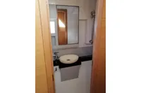 Bathroom interior of 2018 Nautitech 40 Open catamaran with modern sink and mirror.