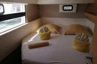 Cozy cabin interior of 2018 Nautitech 40 Open catamaran with neatly arranged bed and towels.