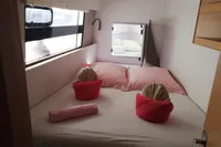Cozy cabin interior of 2018 Nautitech 40 Open catamaran with neatly arranged bed linens.