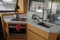 Modern kitchen in a 2018 Nautitech 40 Open catamaran with stove, sink, and oven.