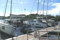 Docked Nautitech 40 Open catamarans, 2018 model, under clear skies at a marina.
