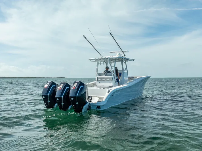  Yacht Photos Pics 2020 Yellowfin 34 boat with triple outboard engines on open water.