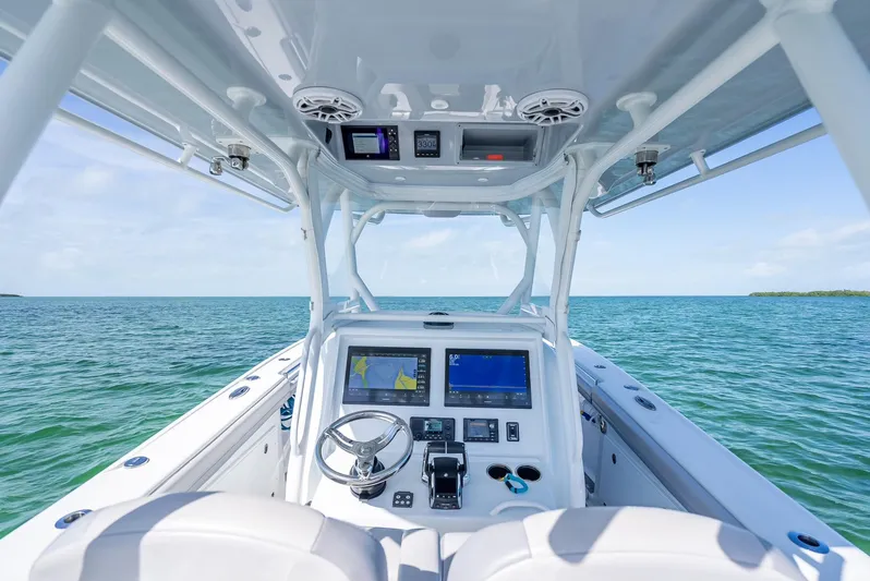  Yacht Photos Pics 2020 Yellowfin 34 boat cockpit with navigation screens on open water.