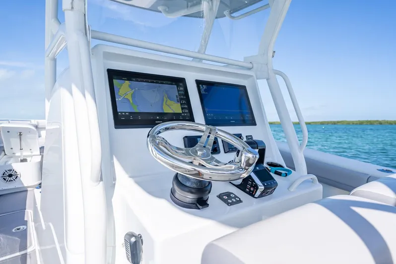  Yacht Photos Pics 2020 Yellowfin 34 boat dashboard with dual navigation screens and steering wheel.