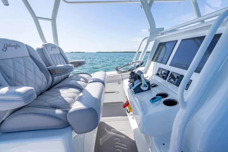  Yacht Photos Pics 2020 Yellowfin 34 boat interior with plush seating and modern dashboard on open water.