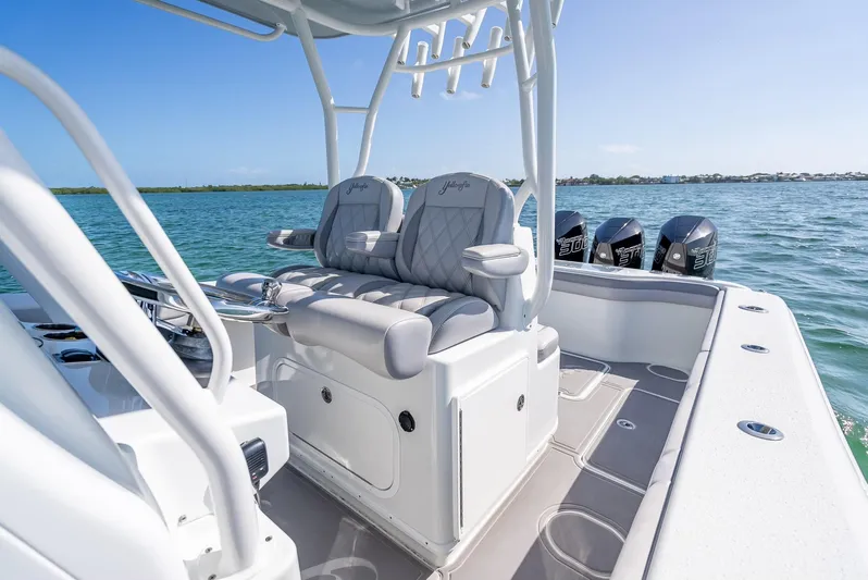  Yacht Photos Pics 2020 Yellowfin 34 boat interior with cushioned seating and multiple outboard motors.