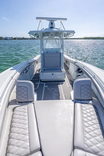  Yacht Photos Pics 2020 Yellowfin 34 boat on water, featuring sleek design and luxurious seating.