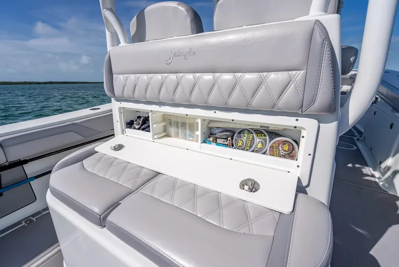  Yacht Photos Pics 2020 Yellowfin 34 boat seat with storage compartment, featuring luxurious gray upholstery.