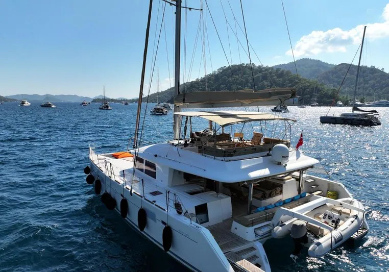  Yacht Photos Pics Luxurious 2011 Lagoon 560 catamaran sailing on a scenic, sunlit bay.