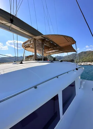  Yacht Photos Pics 2011 Lagoon 560 catamaran with sunshade, sailing in clear blue waters.