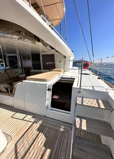 Yacht Photos Pics 2011 Lagoon 560 yacht deck with seating, open hatch, and ocean view.