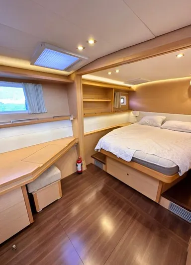  Yacht Photos Pics Luxurious cabin interior of 2011 Lagoon 560 yacht with cozy bed and wooden furnishings.