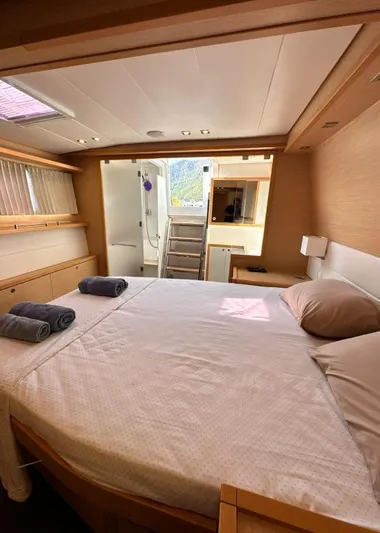  Yacht Photos Pics Luxurious cabin interior of 2011 Lagoon 560 yacht with cozy bed and natural lighting.