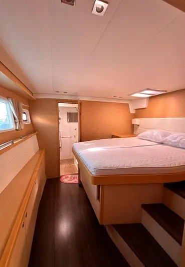  Yacht Photos Pics Luxurious cabin interior of 2011 Lagoon 560 yacht with cozy bed and wooden accents.