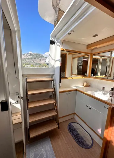  Yacht Photos Pics Interior of 2011 Lagoon 560 yacht with wooden stairs and modern kitchen area.