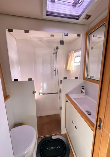  Yacht Photos Pics Modern bathroom in a 2011 Lagoon 560 yacht with shower, sink, and toilet.