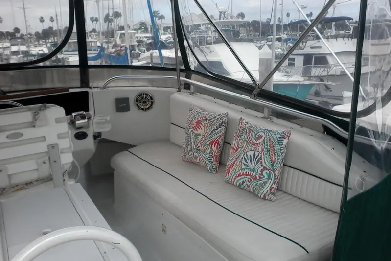 Lusea Yacht Photos Pics 1997 Mainship 350 boat interior with patterned cushions, docked at marina.