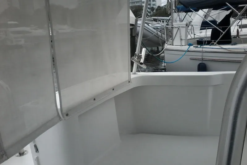 Lusea Yacht Photos Pics 1997 Mainship 350 boat interior with marina view, featuring clean white surfaces and docked vessels.