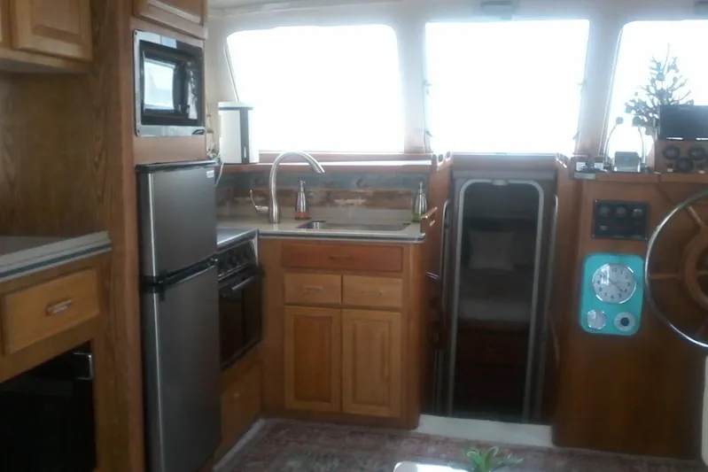 Lusea Yacht Photos Pics Interior of 1997 Mainship 350 yacht with kitchen and helm area.