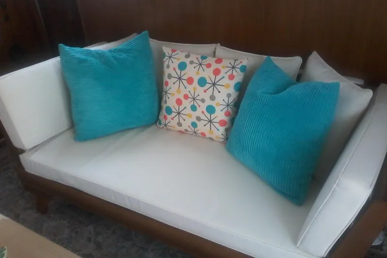 Lusea Yacht Photos Pics White couch with colorful and turquoise pillows, aboard a 1997 Mainship 350.