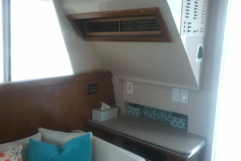 Lusea Yacht Photos Pics Interior of 1997 Mainship 350 yacht with wood paneling and seating area.