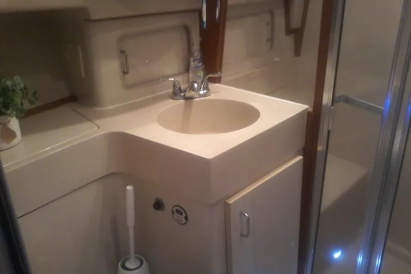 Lusea Yacht Photos Pics Bathroom interior of a 1997 Mainship 350 yacht with sink and shower.