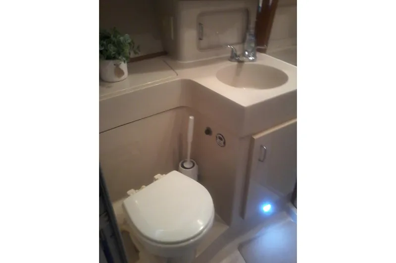 Lusea Yacht Photos Pics Bathroom interior of 1997 Mainship 350 yacht with sink and toilet.