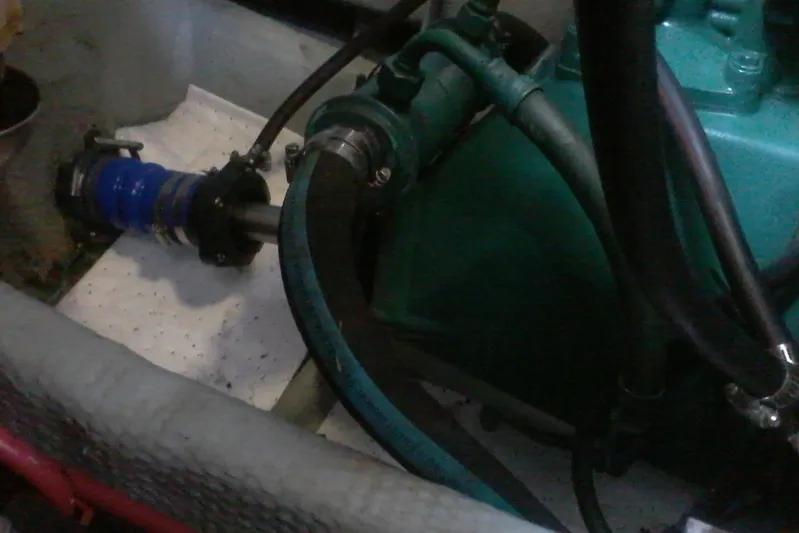 Lusea Yacht Photos Pics Engine compartment of a 1997 Mainship 350 boat, showing hoses and mechanical components.