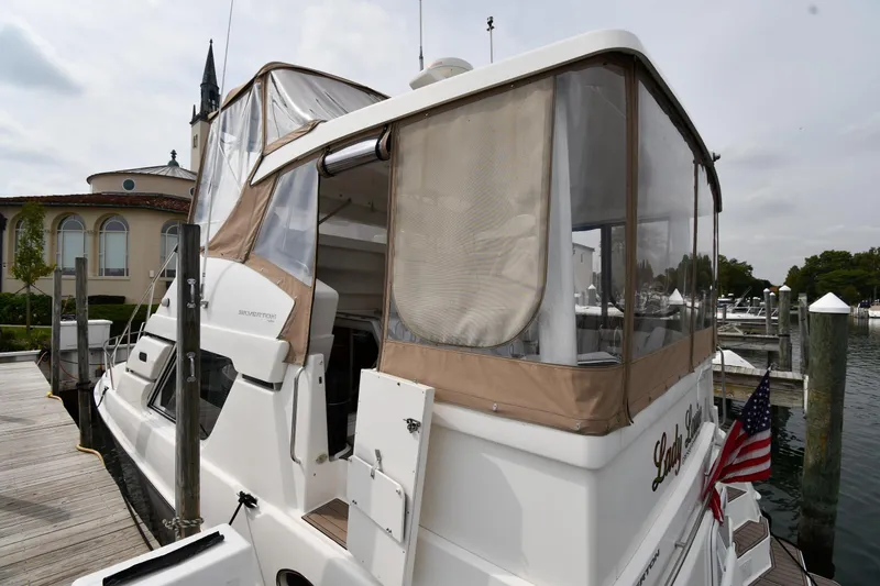 Lady Louise Yacht Photos Pics 2000 Silverton 392 Motor Yacht docked at marina with American flag.