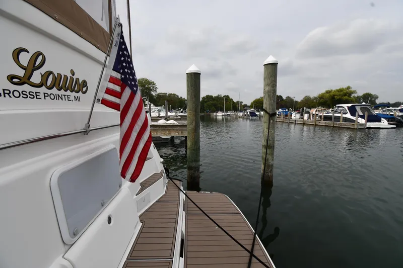 Lady Louise Yacht Photos Pics 2000 Silverton 392 Motor Yacht docked with American flag, Grosse Pointe marina.