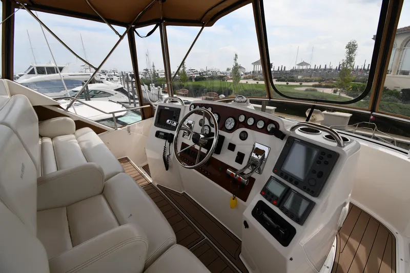 Lady Louise Yacht Photos Pics Interior view of 2000 Silverton 392 Motor Yacht helm with controls and seating.