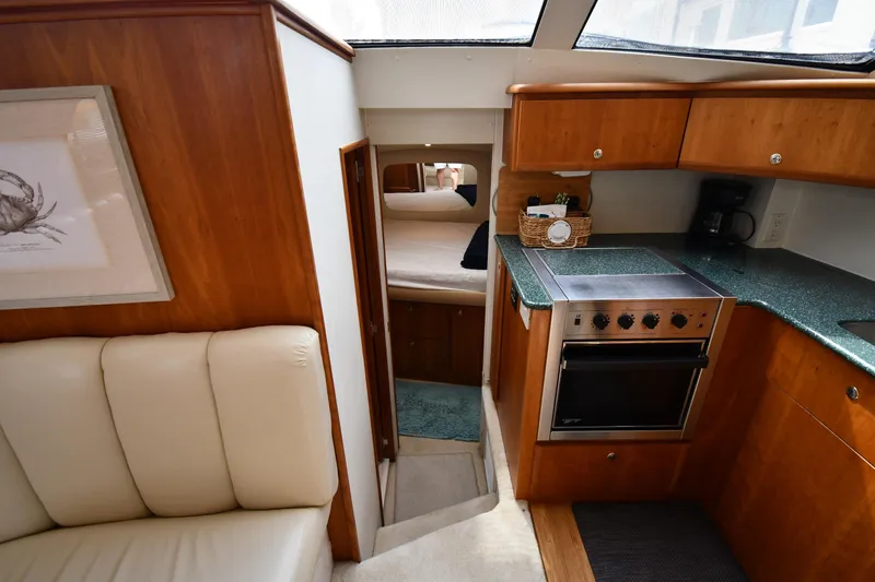 Lady Louise Yacht Photos Pics Interior of 2000 Silverton 392 Motor Yacht with kitchen and cozy cabin view.