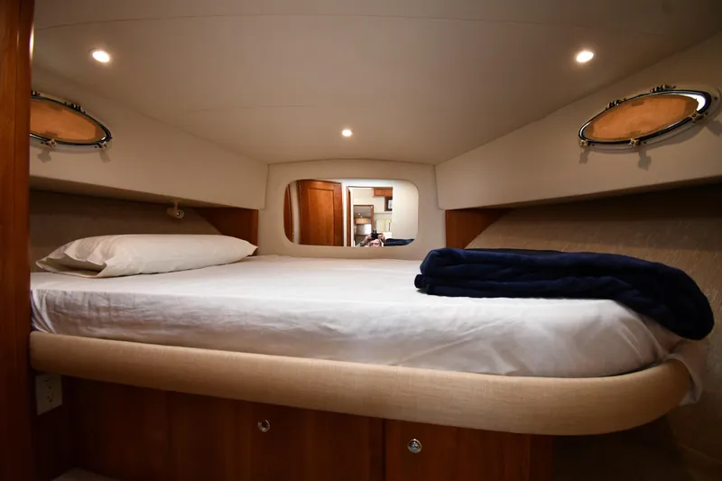 Lady Louise Yacht Photos Pics Cozy bedroom in 2000 Silverton 392 Motor Yacht with portholes and soft lighting.