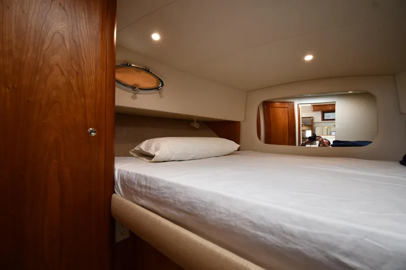 Lady Louise Yacht Photos Pics Interior cabin of 2000 Silverton 392 Motor Yacht with bed and wooden accents.