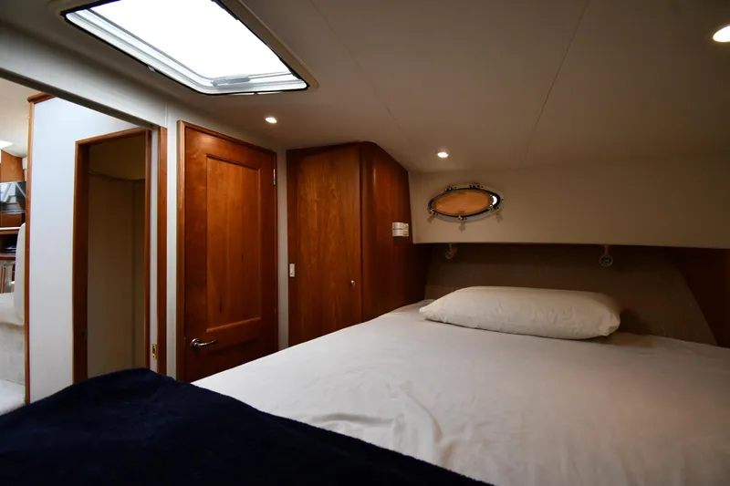 Lady Louise Yacht Photos Pics Interior of 2000 Silverton 392 Motor Yacht bedroom with wooden doors and skylight.