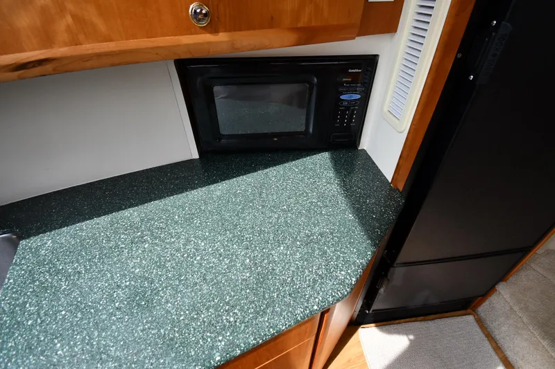 Lady Louise Yacht Photos Pics 2000 Silverton 392 Motor Yacht kitchen with green countertop and built-in microwave.