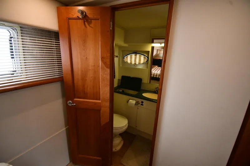 Lady Louise Yacht Photos Pics Interior of 2000 Silverton 392 Motor Yacht bathroom with wooden door and window blinds.