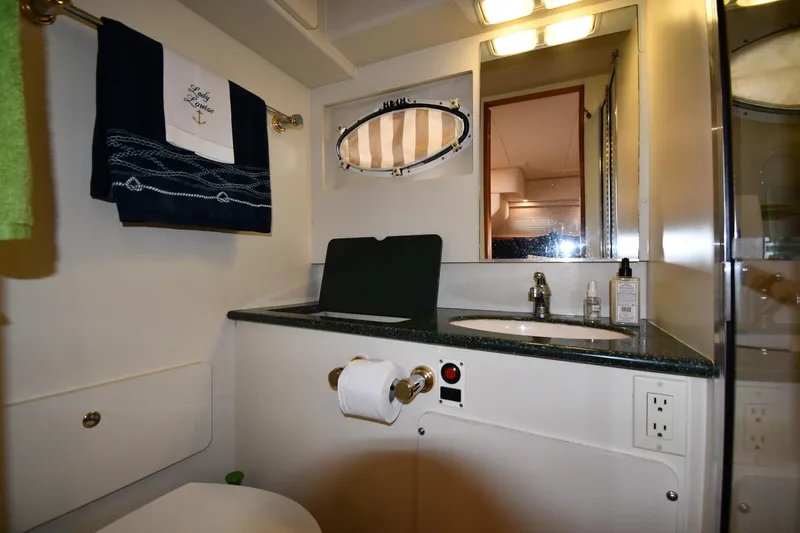 Lady Louise Yacht Photos Pics Bathroom interior of 2000 Silverton 392 Motor Yacht with sink and mirror.