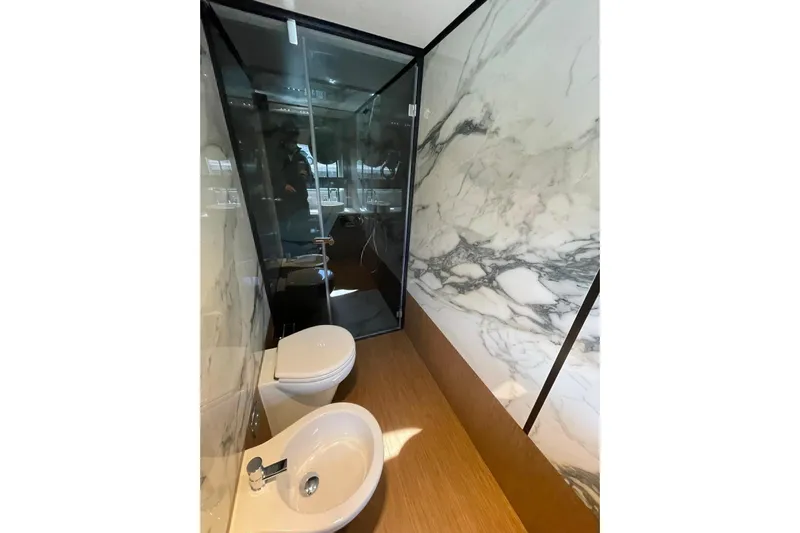  Yacht Photos Pics Luxurious bathroom on 2021 Ferretti Yachts 720, featuring marble walls and modern fixtures.