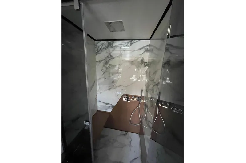  Yacht Photos Pics Luxurious marble bathroom in 2021 Ferretti Yachts 720, featuring modern fixtures and elegant design.
