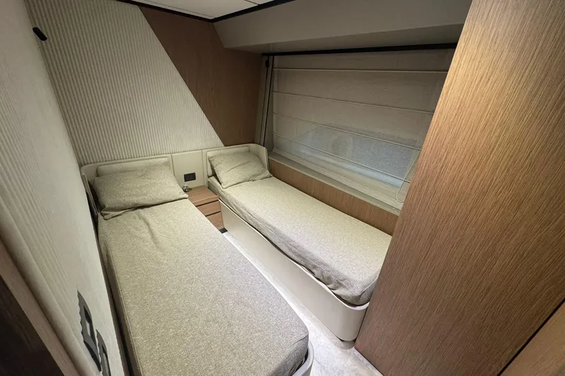  Yacht Photos Pics Interior of 2021 Ferretti Yachts 720, featuring twin beds and modern wood paneling.