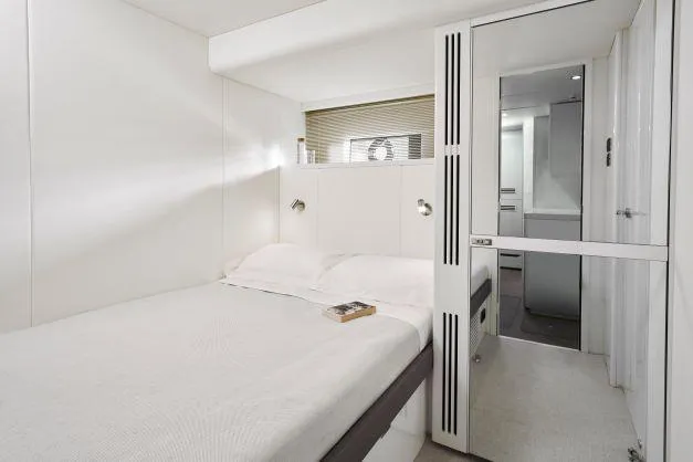  Yacht Photos Pics Luxurious bedroom interior of 2025 Princess Y95 Motor Yacht, featuring modern design and cozy ambiance.