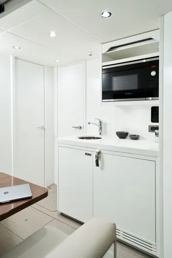  Yacht Photos Pics Modern kitchenette in 2025 Princess Y95 Motor Yacht with sleek white design.