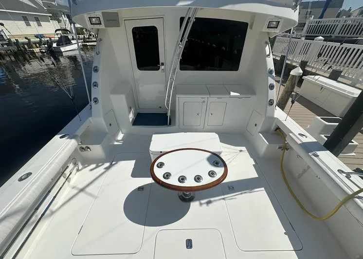 Current Addition Yacht Photos Pics 2006 Henriques 42 Convertible yacht deck with fishing rod holders and seating area.