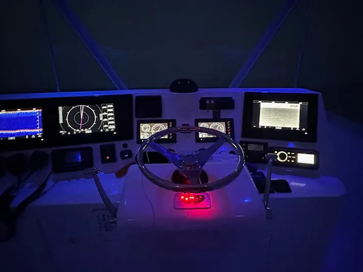 Current Addition Yacht Photos Pics Helm of 2006 Henriques 42 Convertible with illuminated navigation instruments and steering wheel.