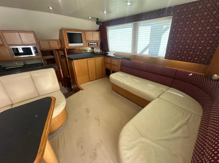 Current Addition Yacht Photos Pics Luxurious interior of a 2006 Henriques 42 Convertible yacht with plush seating and modern amenities.